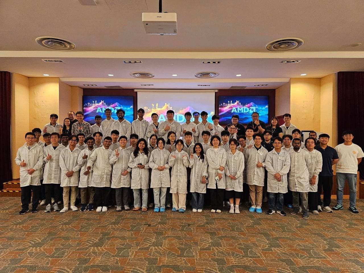 NUS Semiconductor Club members in lab coats during a site visit to AMD